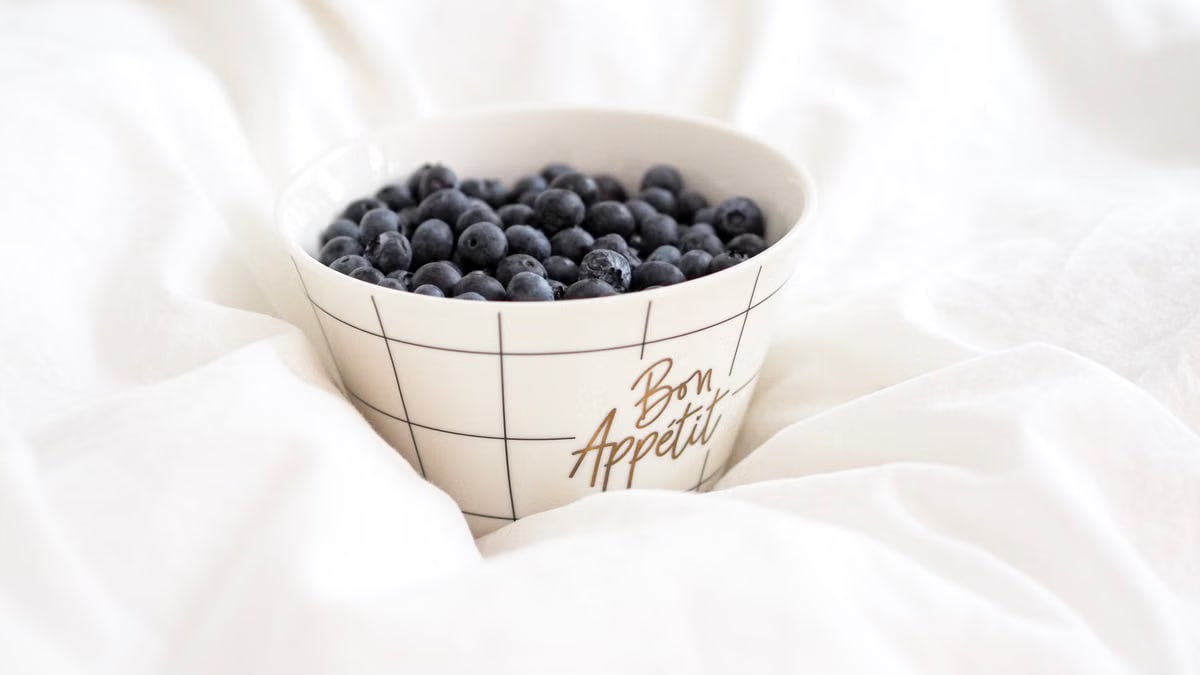 A stylish bowl filled with fresh blueberries, perfect for breakfast or dessert.